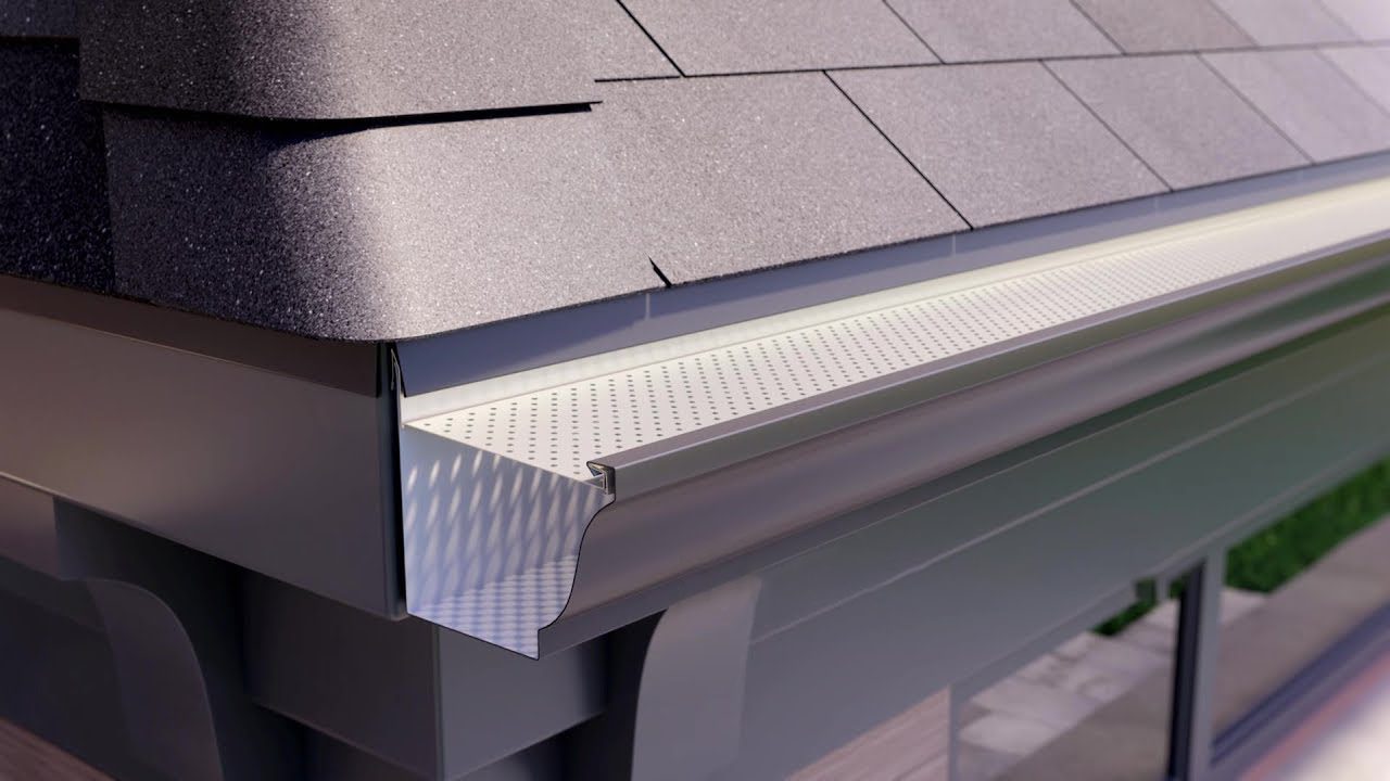Cutaway view of a gutter guard installed over a seamless gutter at the roof edge